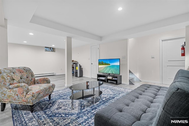 living room with light hardwood / wood-style flooring and a baseboard heating unit