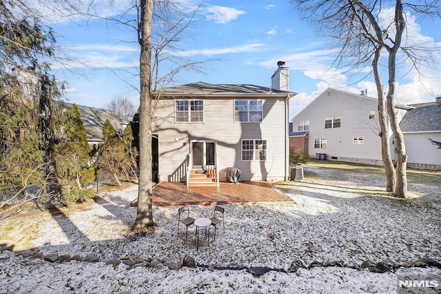 rear view of property featuring a patio area and central air condition unit