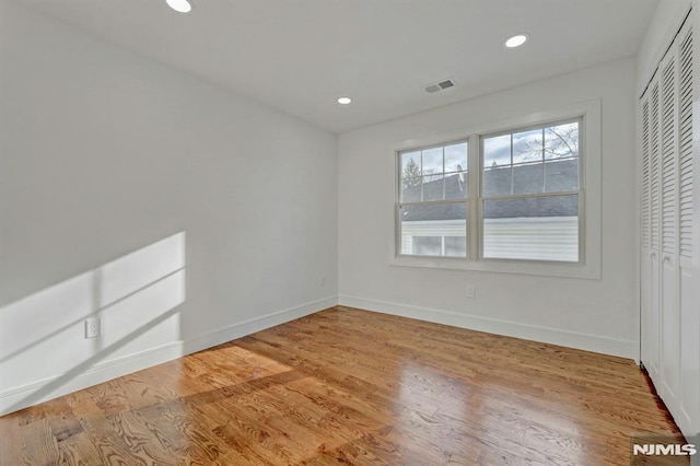 spare room with light hardwood / wood-style floors