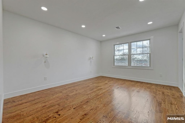 spare room with wood-type flooring