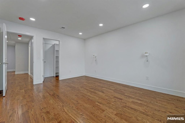 spare room with hardwood / wood-style flooring