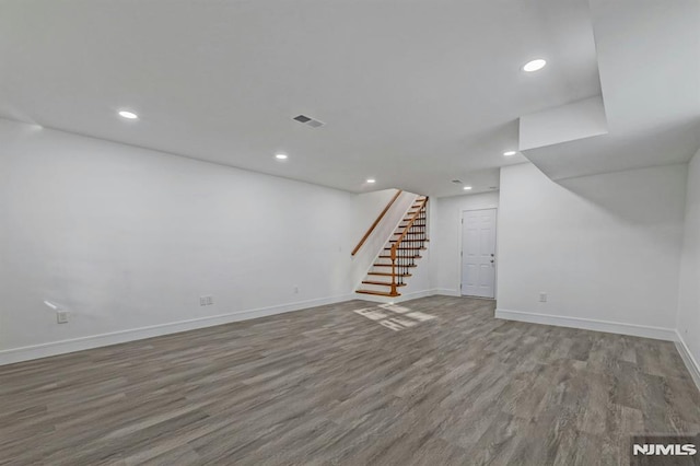 basement with hardwood / wood-style flooring