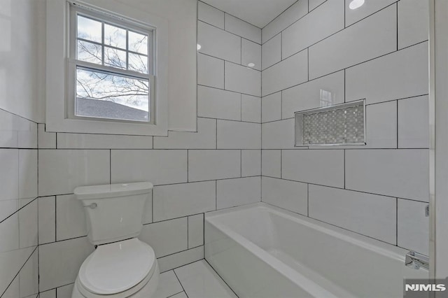 bathroom featuring toilet and tile walls