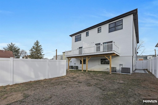 back of house with a deck and central AC