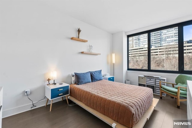 bedroom with dark wood-type flooring