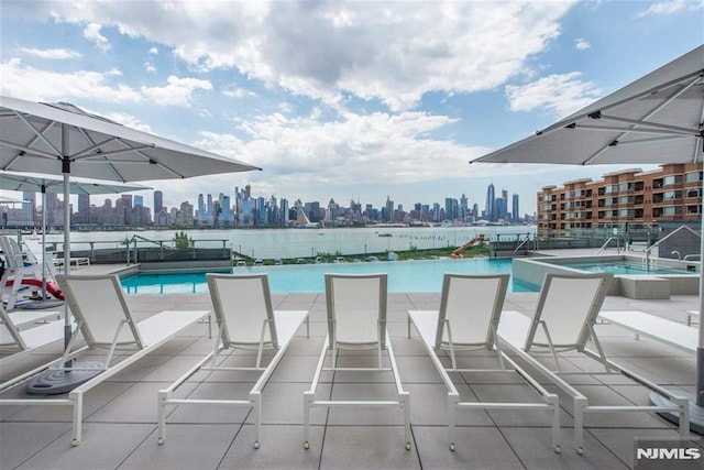 view of swimming pool featuring a hot tub