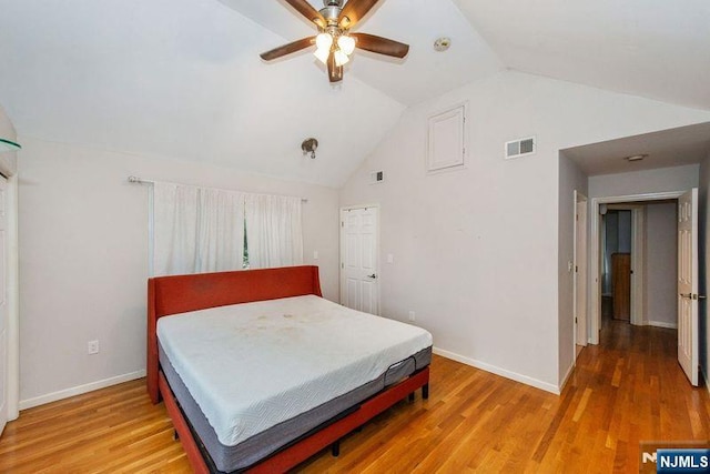 bedroom featuring ceiling fan, hardwood / wood-style floors, and vaulted ceiling