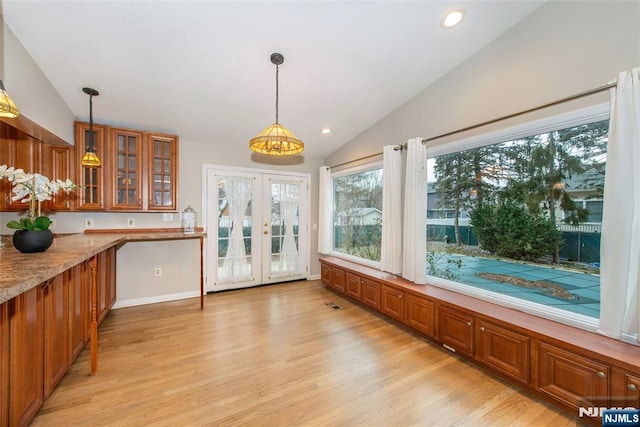 unfurnished sunroom featuring french doors, vaulted ceiling, and a chandelier