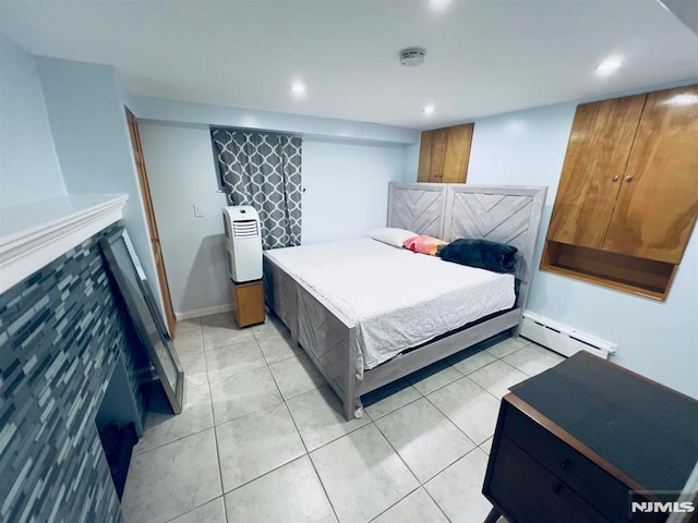 bedroom with light tile patterned flooring and a baseboard heating unit