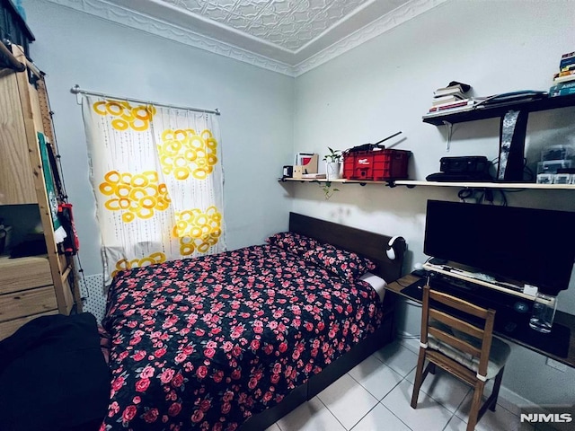 bedroom featuring light tile patterned flooring and a textured ceiling