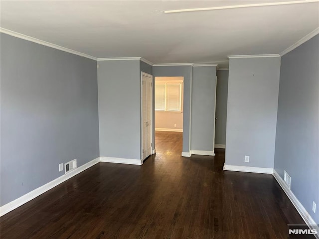 spare room with dark hardwood / wood-style flooring and crown molding