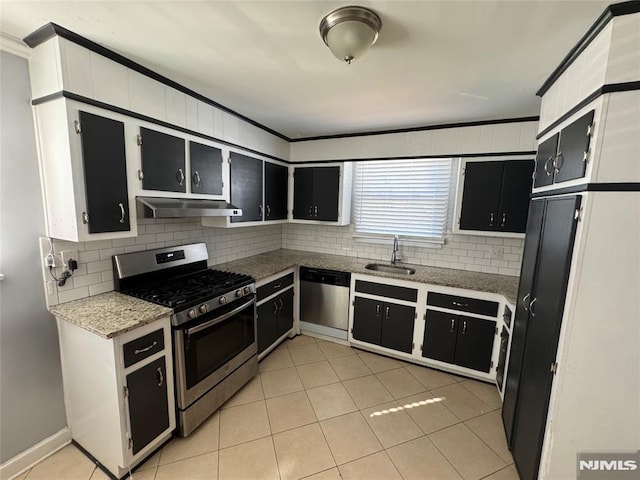 kitchen with decorative backsplash, ventilation hood, stainless steel appliances, sink, and light tile patterned flooring