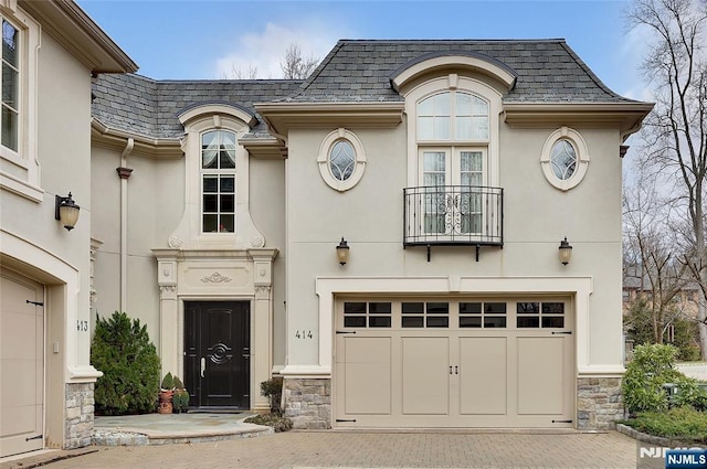 french country home featuring a garage