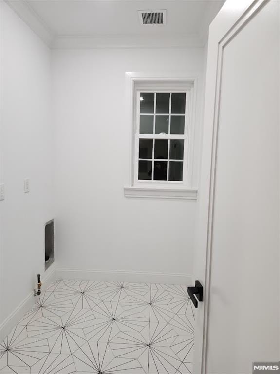 washroom featuring ornamental molding, laundry area, visible vents, and baseboards