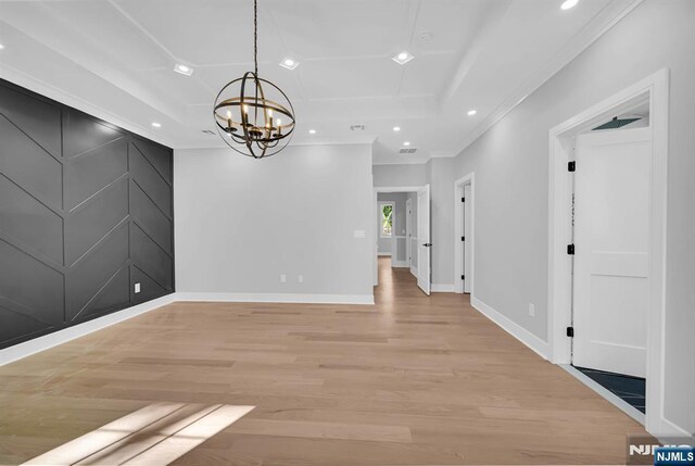 unfurnished dining area with light wood-style flooring, baseboards, a raised ceiling, and recessed lighting