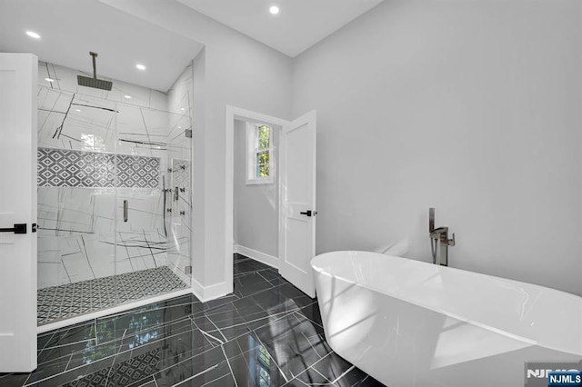 full bathroom with a marble finish shower, recessed lighting, a freestanding bath, tile patterned flooring, and baseboards