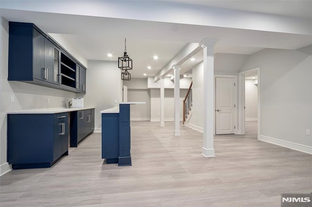 kitchen with a kitchen island, blue cabinetry, light hardwood / wood-style flooring, and pendant lighting