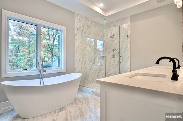 bathroom featuring separate shower and tub and vanity