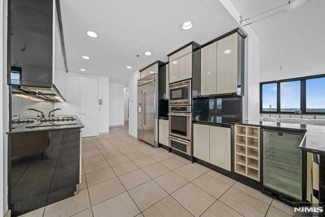 kitchen featuring wine cooler, light tile patterned flooring, and appliances with stainless steel finishes