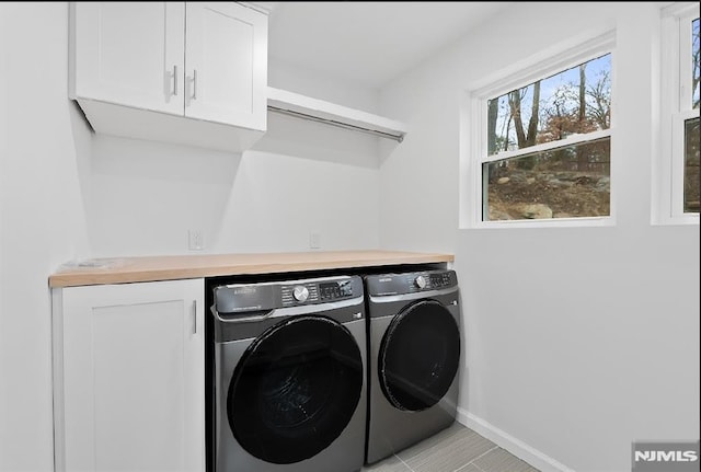 laundry area featuring cabinets and independent washer and dryer