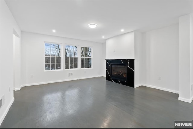 unfurnished living room featuring dark hardwood / wood-style floors