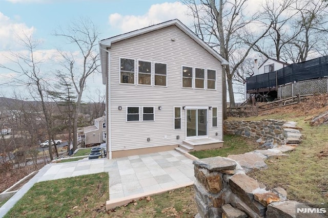 back of property featuring a yard and a patio