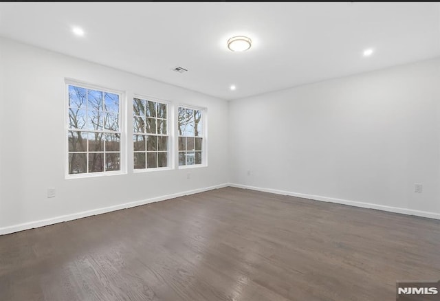 unfurnished room with dark hardwood / wood-style flooring