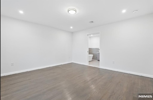 empty room with dark hardwood / wood-style flooring