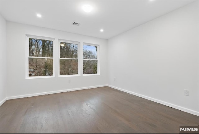 unfurnished room with dark hardwood / wood-style floors