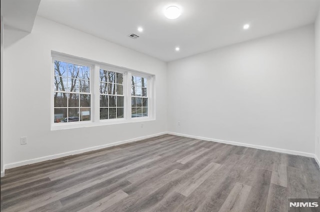 unfurnished room featuring hardwood / wood-style flooring