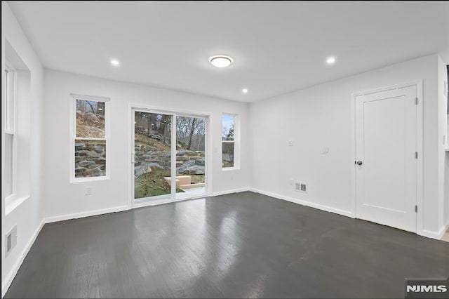 unfurnished room with dark hardwood / wood-style floors