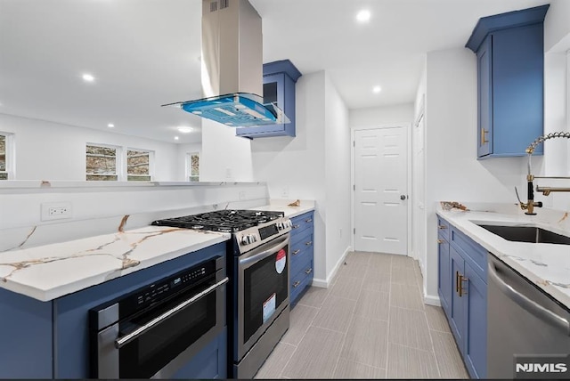 kitchen with blue cabinetry, sink, light stone counters, range hood, and appliances with stainless steel finishes