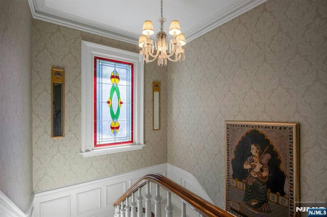 details with ornamental molding and a notable chandelier