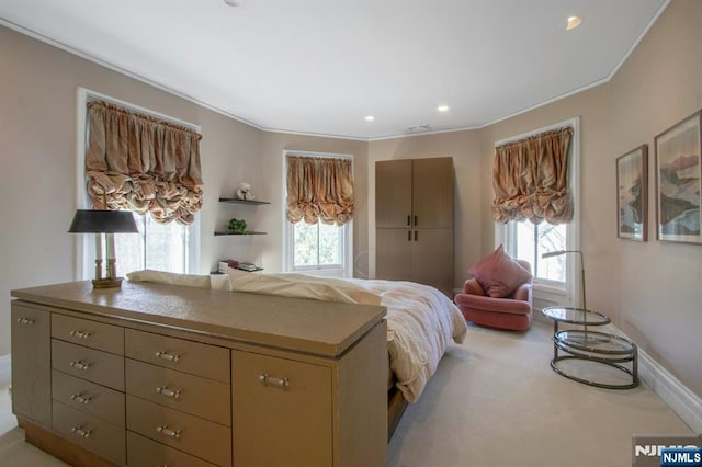 bedroom featuring light colored carpet, multiple windows, and ornamental molding