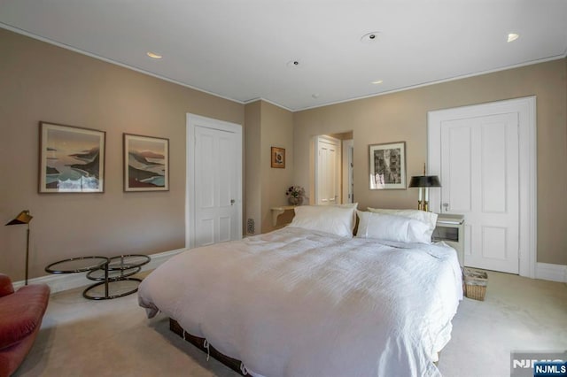 carpeted bedroom featuring baseboards, ornamental molding, and recessed lighting