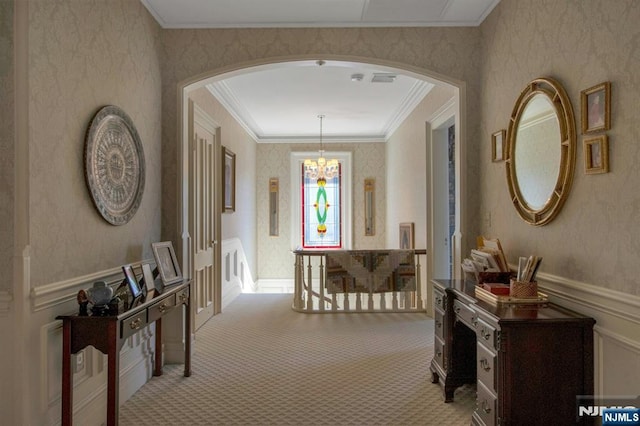 hall with crown molding, arched walkways, and wallpapered walls