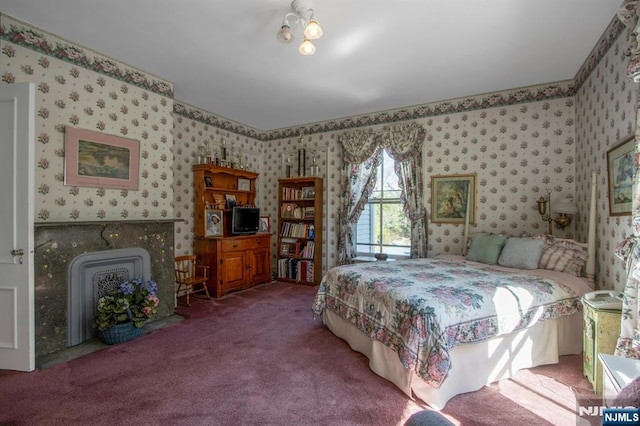 carpeted bedroom with wallpapered walls
