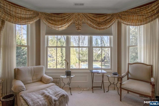 sitting room featuring ornamental molding, carpet flooring, and visible vents
