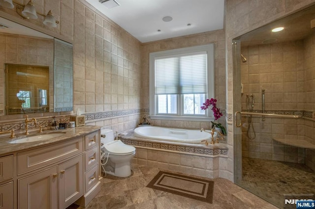full bath with tile walls, visible vents, a shower stall, a garden tub, and vanity