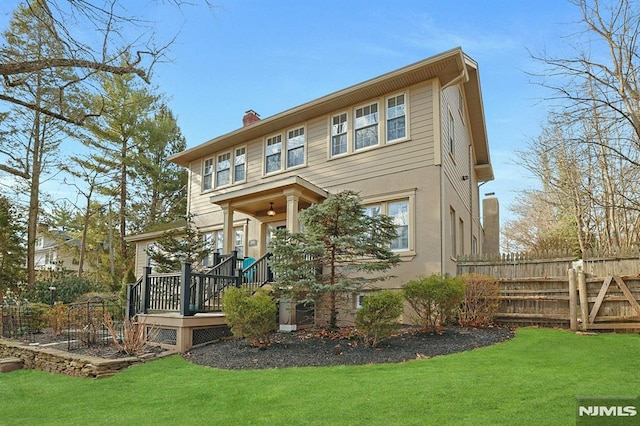 back of house featuring a yard