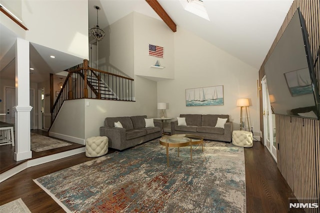 living room with beam ceiling and high vaulted ceiling