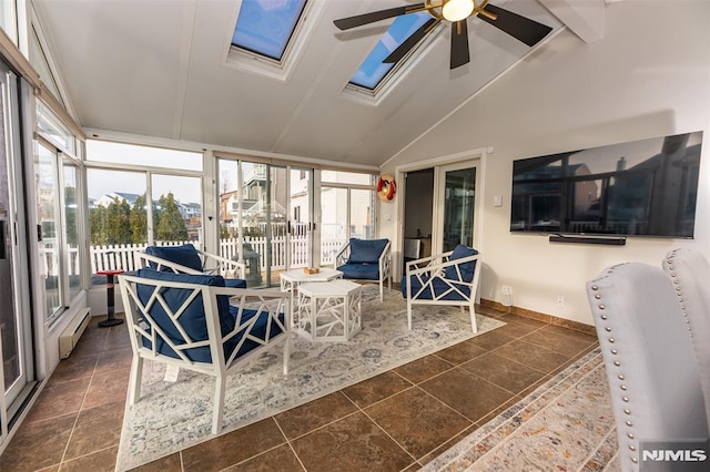 sunroom featuring baseboard heating, ceiling fan, plenty of natural light, and lofted ceiling with skylight