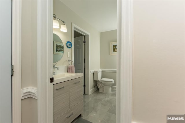 bathroom featuring vanity and toilet