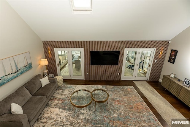 living room with french doors, dark hardwood / wood-style flooring, and a skylight