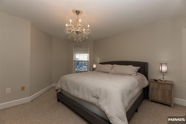 carpeted bedroom with a notable chandelier