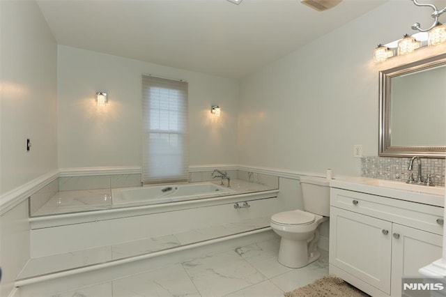 bathroom with decorative backsplash, a bath, vanity, and toilet