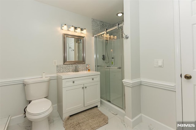 bathroom featuring vanity, backsplash, toilet, walk in shower, and a chandelier