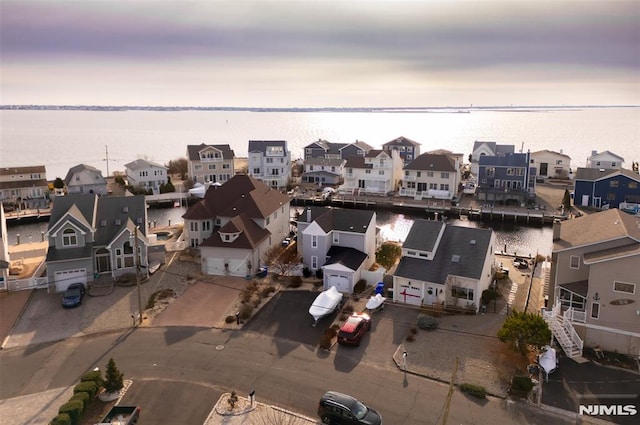 aerial view at dusk with a water view