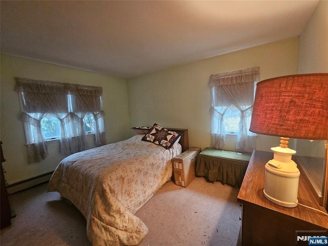 bedroom with carpet floors and baseboard heating