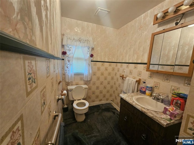 bathroom featuring toilet and vanity